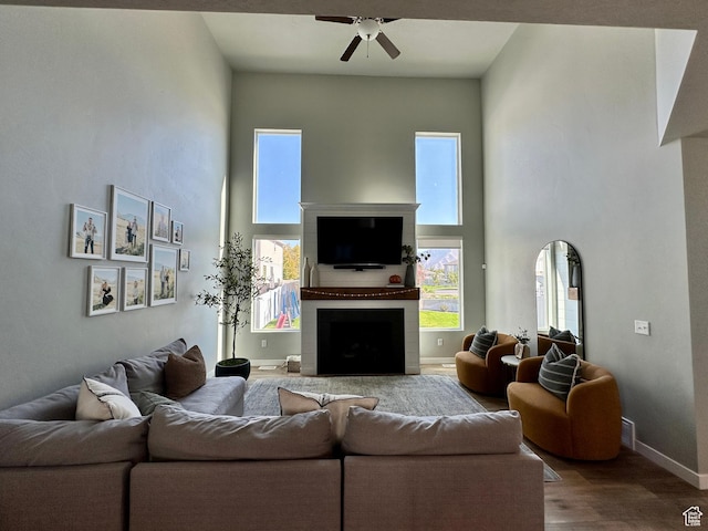 980 W 1275 S, Springville, UT 84663 - living area with wood finished floors, ceiling fan, a fireplace, baseboards, and a high ceiling