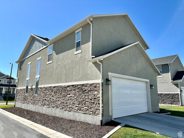 980 W 1275 S, Springville, UT 84663 - view of side of property with board and batten siding, stucco siding, concrete driveway, and stone siding