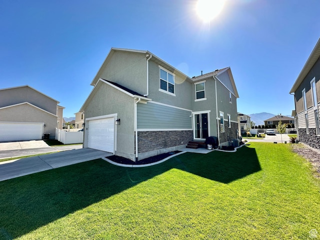 980 W 1275 S, Springville, UT 84663 - back of property featuring a garage, a residential view, stucco siding, a lawn, and entry steps