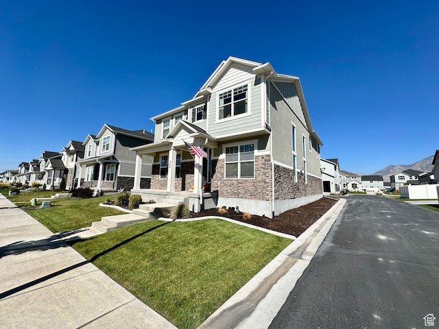 980 W 1275 S, Springville, UT 84663 - view of front of home featuring a porch, stucco siding, a residential view, stone siding, and a front yard