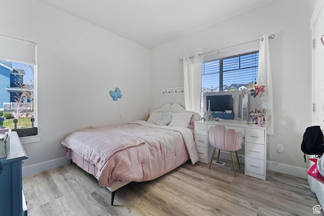 6463 W Maple Valley Cir S Unit 1030, West Jordan, UT 84081 - bedroom with baseboards, wood finished floors, and multiple windows