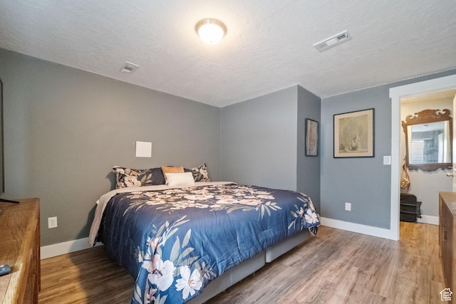6463 W Maple Valley Cir S Unit 1030, West Jordan, UT 84081 - bedroom featuring wood finished floors, visible vents, a textured ceiling, and baseboards