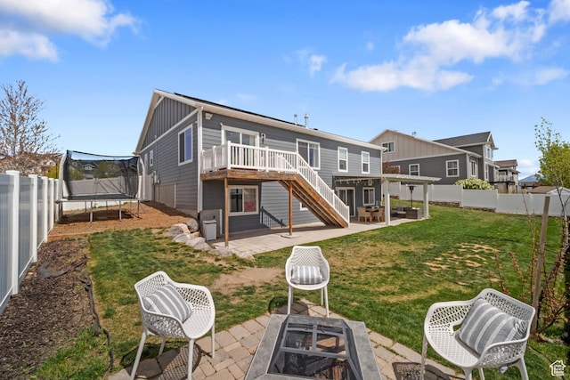 6463 W Maple Valley Cir S Unit 1030, West Jordan, UT 84081 - back of property featuring a trampoline, board and batten siding, a patio, a wooden deck, and stairs