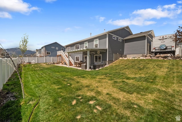 6463 W Maple Valley Cir S Unit 1030, West Jordan, UT 84081 - rear view of property with board and batten siding, a fenced backyard, a yard, stairway, and a patio area