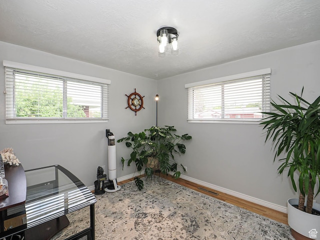 123 Lynnwood Dr, Clearfield, UT 84015 - office area with a textured ceiling, wood finished floors, visible vents, and baseboards