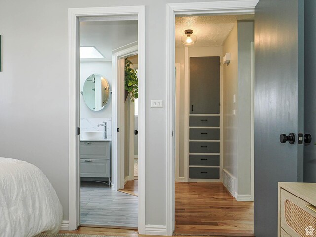 123 Lynnwood Dr, Clearfield, UT 84015 - bedroom with wood finished floors, baseboards, visible vents, and a sink