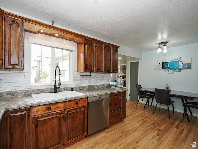 123 Lynnwood Dr, Clearfield, UT 84015 - kitchen featuring light wood-style floors, tasteful backsplash, dishwasher, and a sink
