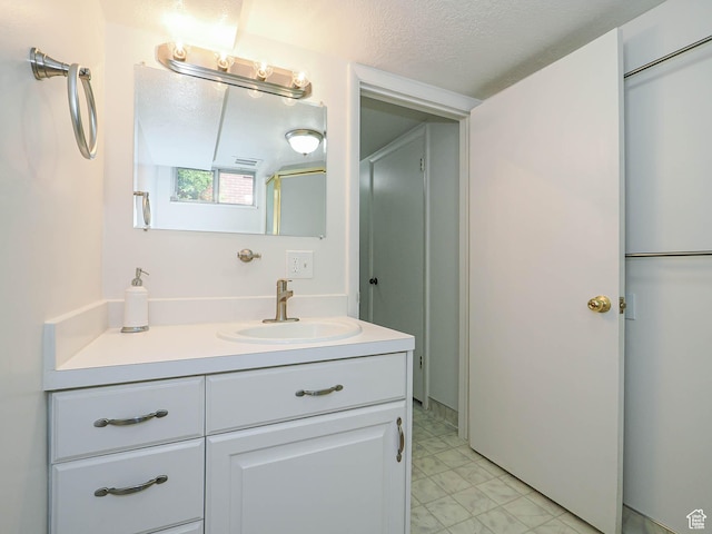 123 Lynnwood Dr, Clearfield, UT 84015 - bathroom featuring tile patterned floors, a textured ceiling, and vanity