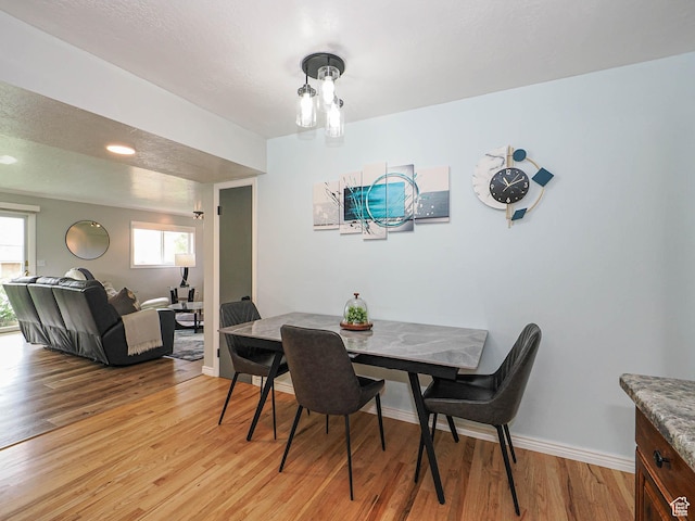123 Lynnwood Dr, Clearfield, UT 84015 - dining area featuring baseboards, light wood-style floors, and plenty of natural light