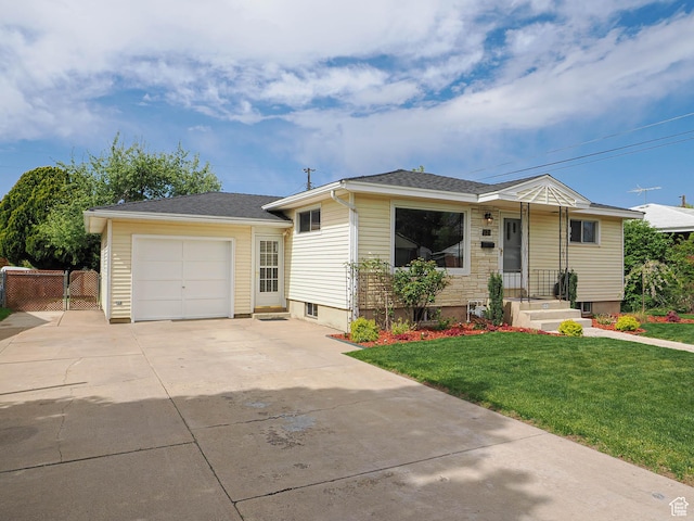 123 Lynnwood Dr, Clearfield, UT 84015 - view of front of home with a front lawn, driveway, and an attached garage