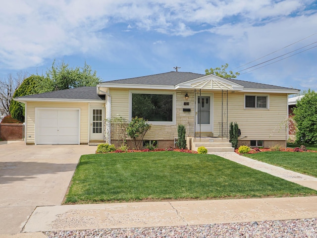 view of front of property with concrete driveway, a front yard, and a garage