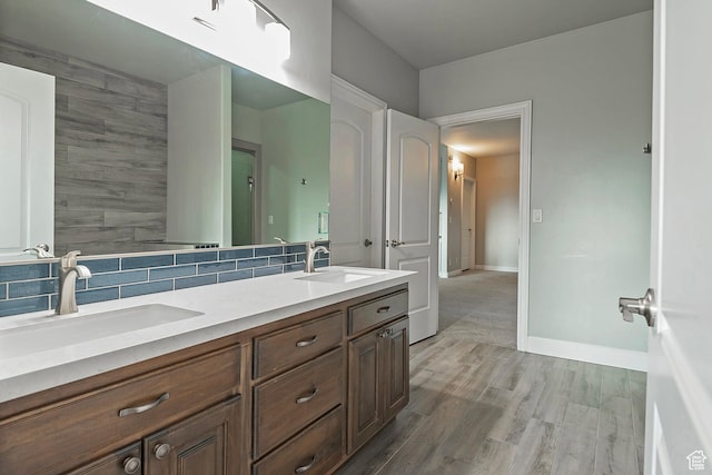 11274 S Eagle View Dr, Sandy, UT 84092 - full bathroom with double vanity, wood finished floors, baseboards, and a sink