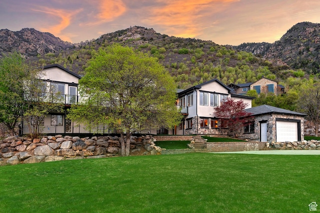 11274 S Eagle View Dr, Sandy, UT 84092 - view of front of house with a lawn, a mountain view, stone siding, and an attached garage