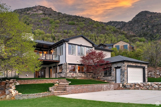 11274 S Eagle View Dr, Sandy, UT 84092 - view of front of house with a mountain view, a yard, an attached garage, and stone siding