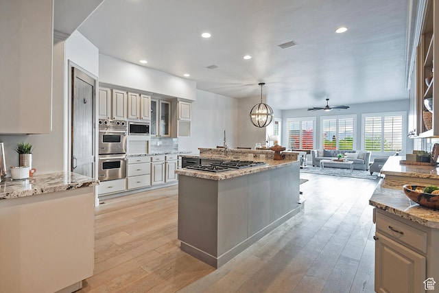 11274 S Eagle View Dr, Sandy, UT 84092 - kitchen featuring recessed lighting, light wood-style flooring, light stone counters, stainless steel appliances, and open floor plan