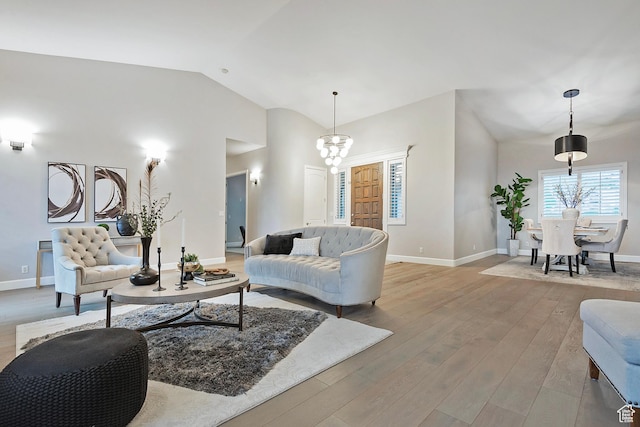 11274 S Eagle View Dr, Sandy, UT 84092 - living room with a chandelier, baseboards, lofted ceiling, and light wood-style floors