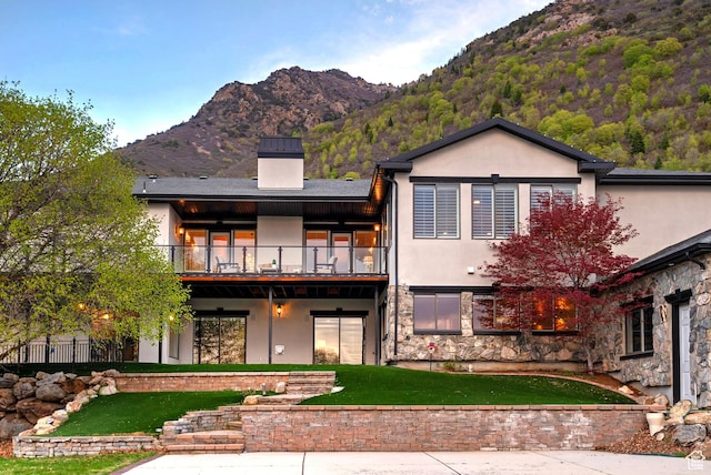 11274 S Eagle View Dr, Sandy, UT 84092 - back of property featuring a balcony, a chimney, a lawn, a mountain view, and stucco siding