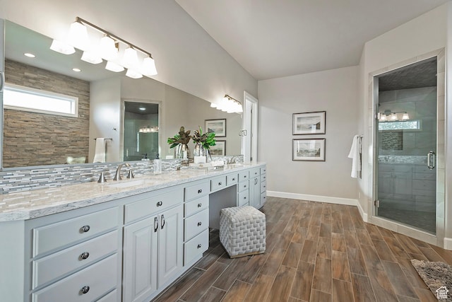 11274 S Eagle View Dr, Sandy, UT 84092 - bathroom with baseboards, a shower stall, double vanity, and a sink