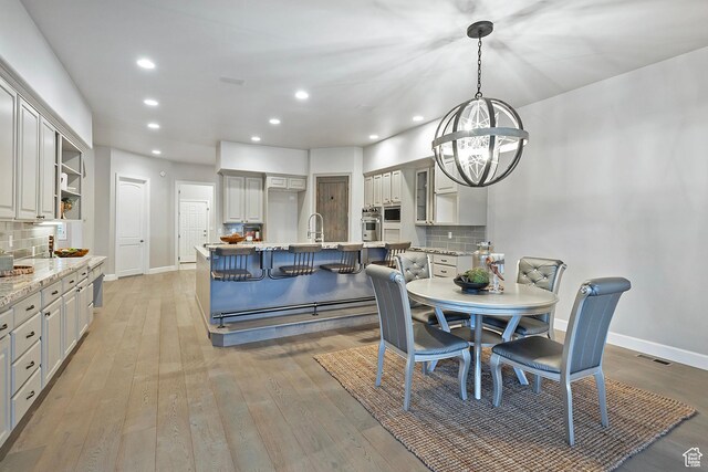 11274 S Eagle View Dr, Sandy, UT 84092 - dining space with recessed lighting, a notable chandelier, visible vents, light wood-style flooring, and baseboards