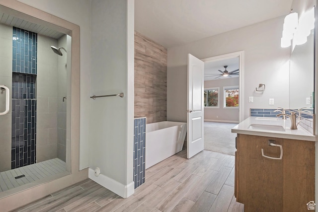 11274 S Eagle View Dr, Sandy, UT 84092 - bathroom featuring baseboards, wood tiled floor, a freestanding tub, and a stall shower