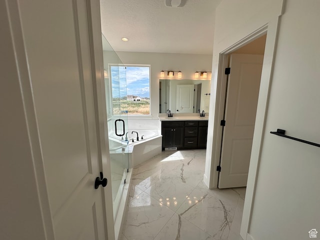 287 E 1150 N Unit 73, Salem, UT 84653 - full bathroom with double vanity, a garden tub, marble tiled flooring, a textured ceiling, and a shower with door
