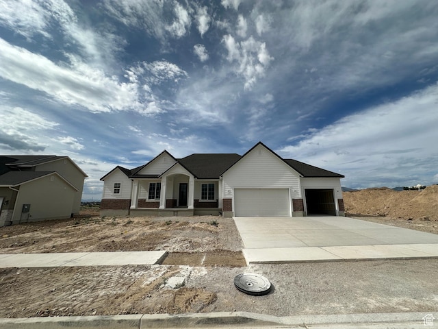 287 E 1150 N Unit 73, Salem, UT 84653 - view of front facade featuring an attached garage, brick siding, a porch, and concrete driveway
