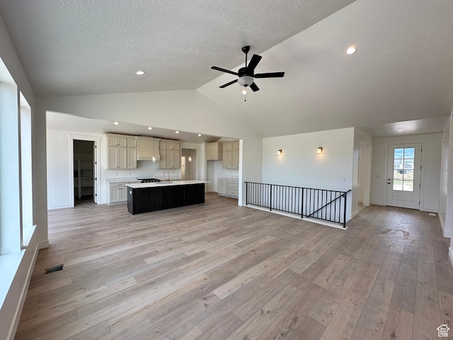287 E 1150 N Unit 73, Salem, UT 84653 - unfurnished living room featuring a ceiling fan, a textured ceiling, vaulted ceiling, light wood-type flooring, and recessed lighting