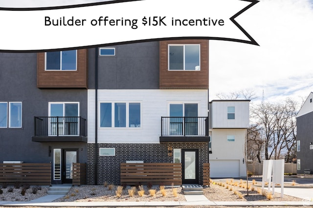 4475 S 500 E Unit 62, Millcreek, UT 84107 - view of front facade featuring a balcony, stucco siding, and brick siding