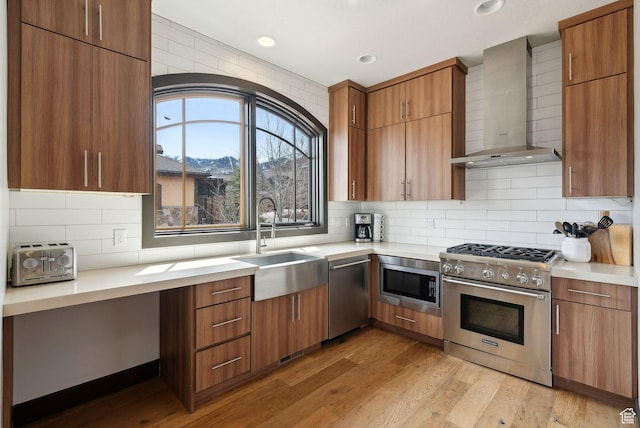 4186 Fairway Ln Unit G6, Park City, UT 84098 - kitchen featuring light countertops, appliances with stainless steel finishes, wall chimney range hood, and a sink