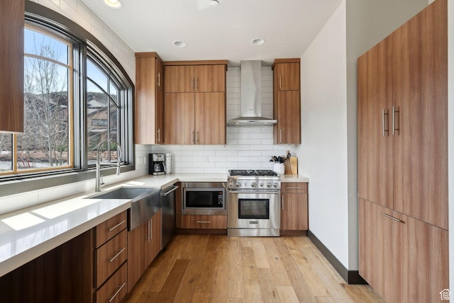 4186 Fairway Ln Unit G6, Park City, UT 84098 - kitchen featuring light wood finished floors, stainless steel appliances, wall chimney exhaust hood, backsplash, and light countertops