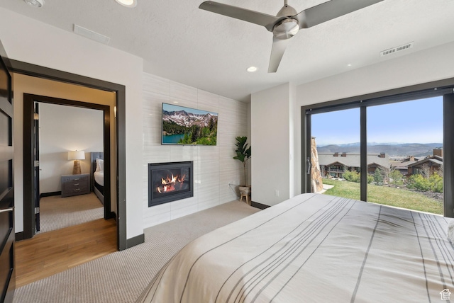 4186 Fairway Ln Unit G6, Park City, UT 84098 - bedroom with a fireplace, wood finished floors, visible vents, and recessed lighting