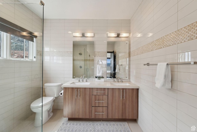 4186 Fairway Ln Unit G6, Park City, UT 84098 - bathroom featuring tile walls, a stall shower, tile patterned floors, and a sink