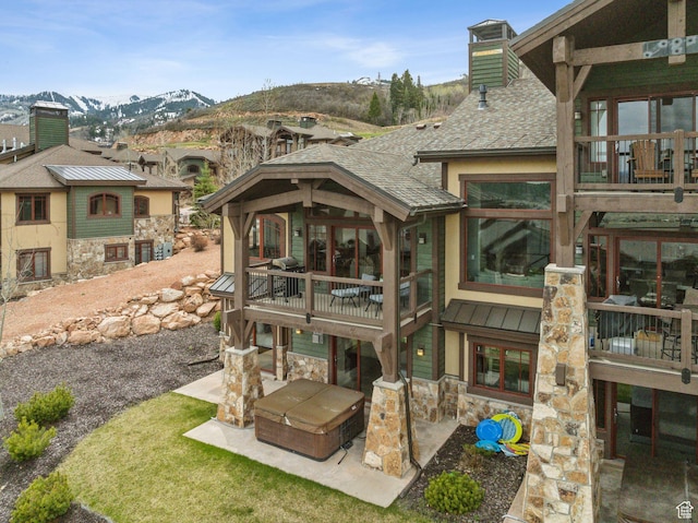 4186 Fairway Ln Unit G6, Park City, UT 84098 - rear view of house featuring a chimney, stone siding, a mountain view, a patio area, and a balcony