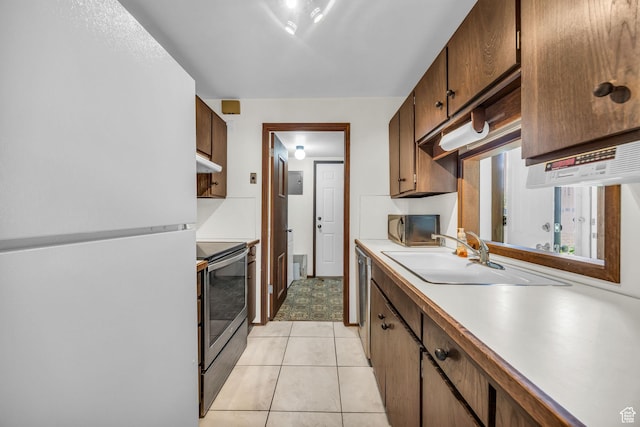4169 S Village Ln Unit A, Taylorsville, UT 84129 - kitchen with a sink, light countertops, stainless steel range with electric stovetop, freestanding refrigerator, and under cabinet range hood