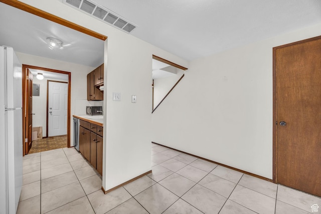 4169 S Village Ln Unit A, Taylorsville, UT 84129 - kitchen featuring light tile patterned floors, stainless steel dishwasher, visible vents, light countertops, and freestanding refrigerator