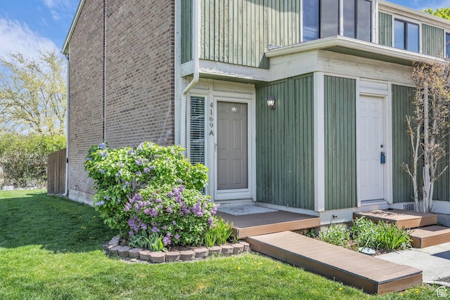 4169 S Village Ln Unit A, Taylorsville, UT 84129 - property entrance featuring a lawn and brick siding