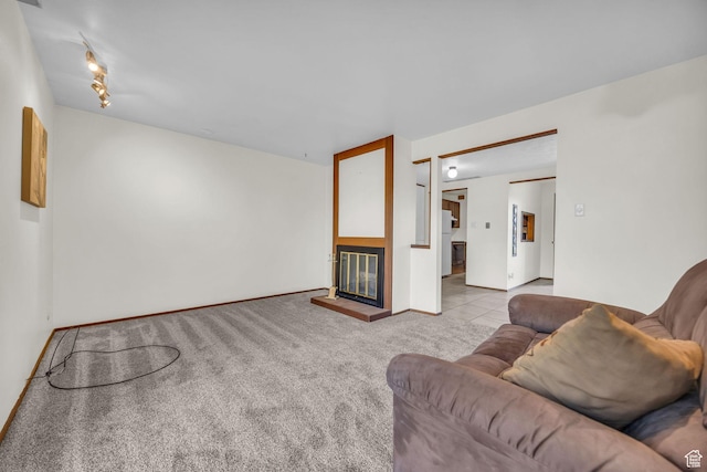 4169 S Village Ln Unit A, Taylorsville, UT 84129 - living room with baseboards, carpet flooring, and a glass covered fireplace