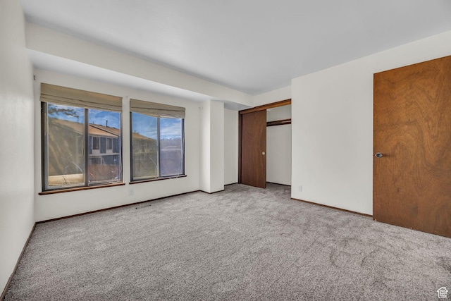 4169 S Village Ln Unit A, Taylorsville, UT 84129 - unfurnished bedroom with a closet, carpet flooring, and baseboards