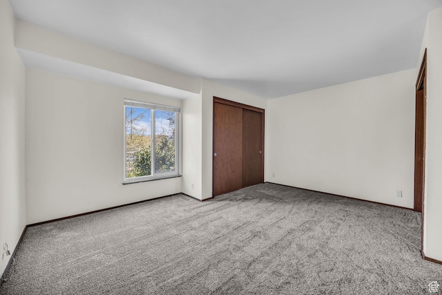 4169 S Village Ln Unit A, Taylorsville, UT 84129 - unfurnished bedroom featuring baseboards, a closet, and carpet
