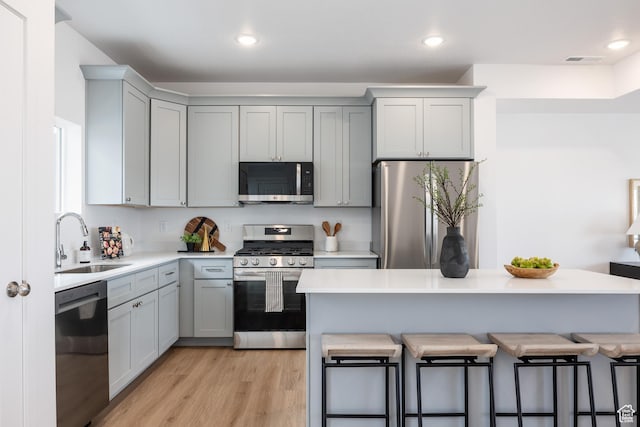 4479 S 500 E Unit 65, Millcreek, UT 84107 - kitchen featuring gray cabinetry, stainless steel appliances, a breakfast bar, and a sink