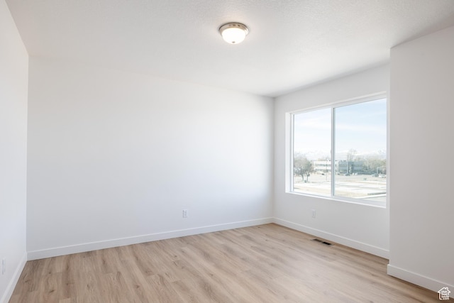 4479 S 500 E Unit 65, Millcreek, UT 84107 - unfurnished room featuring baseboards, visible vents, and light wood-style floors