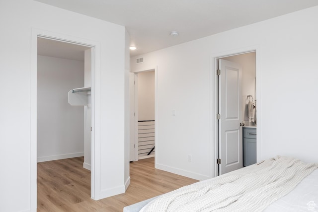 4479 S 500 E Unit 65, Millcreek, UT 84107 - bedroom with light wood-style flooring, visible vents, a closet, baseboards, and a walk in closet