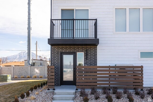 4479 S 500 E Unit 65, Millcreek, UT 84107 - entrance to property with brick siding, fence, a mountain view, and a balcony