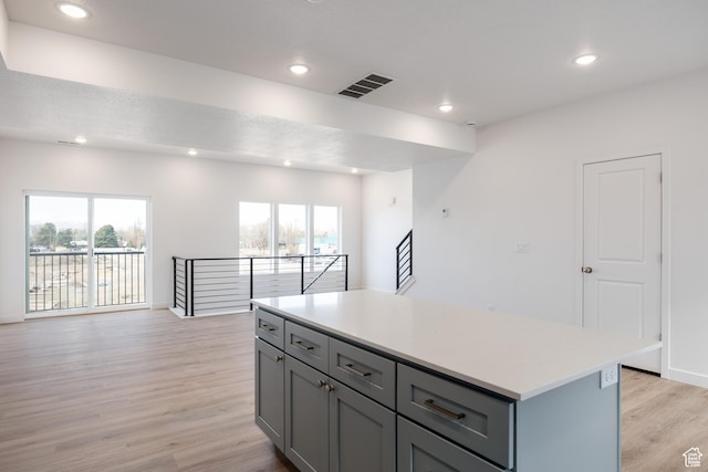 4479 S 500 E Unit 65, Millcreek, UT 84107 - kitchen with gray cabinetry, light wood finished floors, visible vents, and open floor plan
