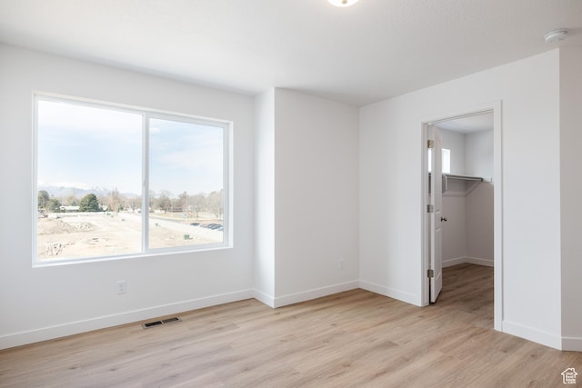 4479 S 500 E Unit 65, Millcreek, UT 84107 - unfurnished bedroom featuring light wood finished floors, visible vents, multiple windows, and baseboards