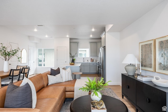 4479 S 500 E Unit 65, Millcreek, UT 84107 - living room featuring recessed lighting, visible vents, baseboards, and light wood-type flooring