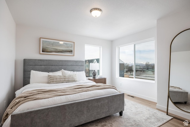 4479 S 500 E Unit 65, Millcreek, UT 84107 - bedroom with baseboards, visible vents, and wood finished floors