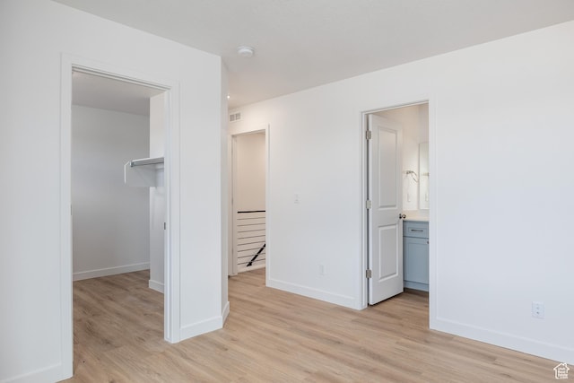 4479 S 500 E Unit 65, Millcreek, UT 84107 - unfurnished bedroom with light wood finished floors, visible vents, a spacious closet, and baseboards