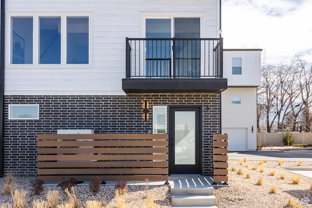 4479 S 500 E Unit 65, Millcreek, UT 84107 - exterior space featuring brick siding, a balcony, and an attached garage