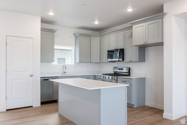4479 S 500 E Unit 65, Millcreek, UT 84107 - kitchen with gray cabinets, stainless steel appliances, a center island, a sink, and light wood-type flooring